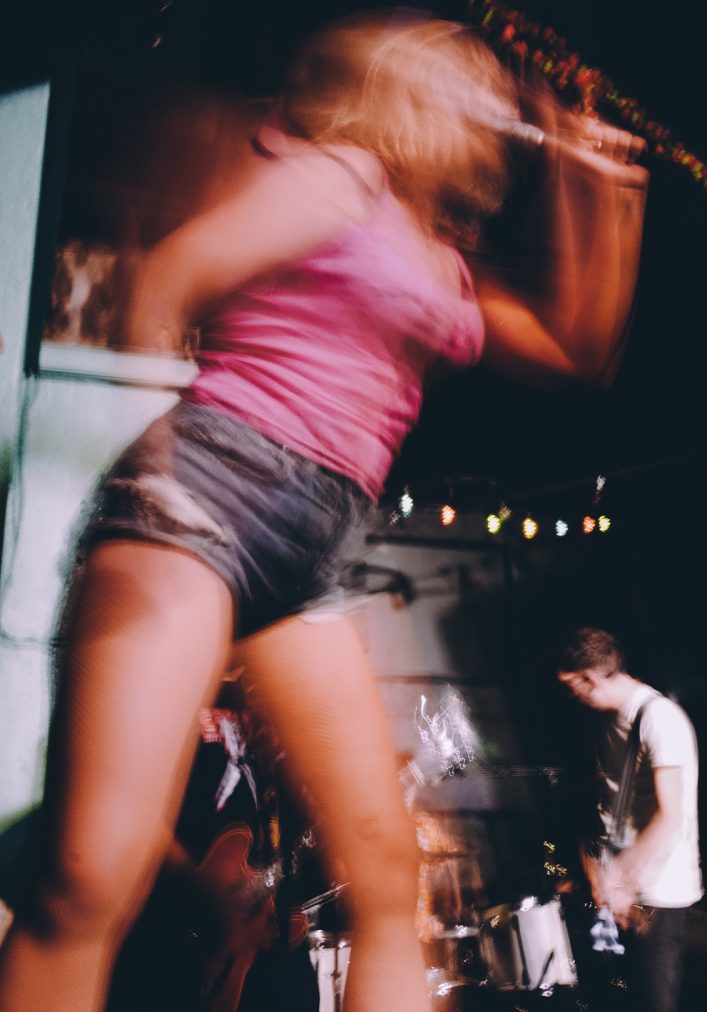 Artistic photo of Caroline Omberg wearing pink shirt and shorts