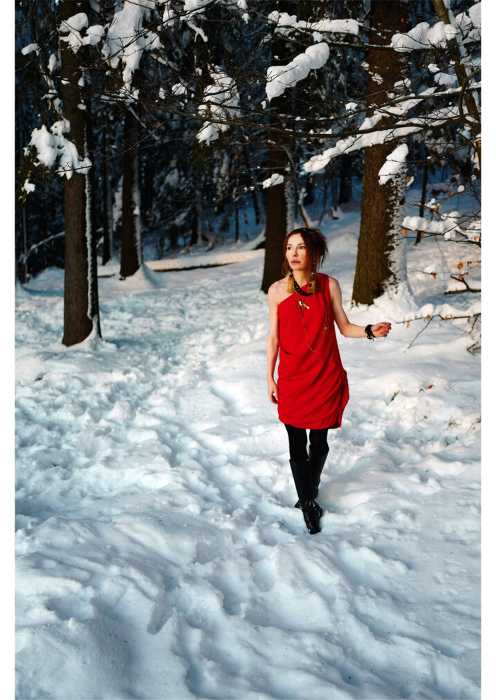 martha may walking through the winter forest in a red dress oslo norway